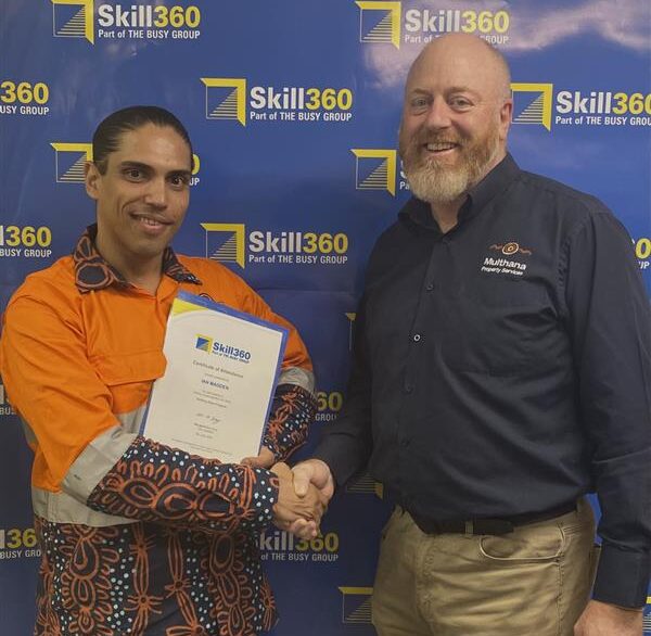 First Nations man receiving certificate standing next to employer.
